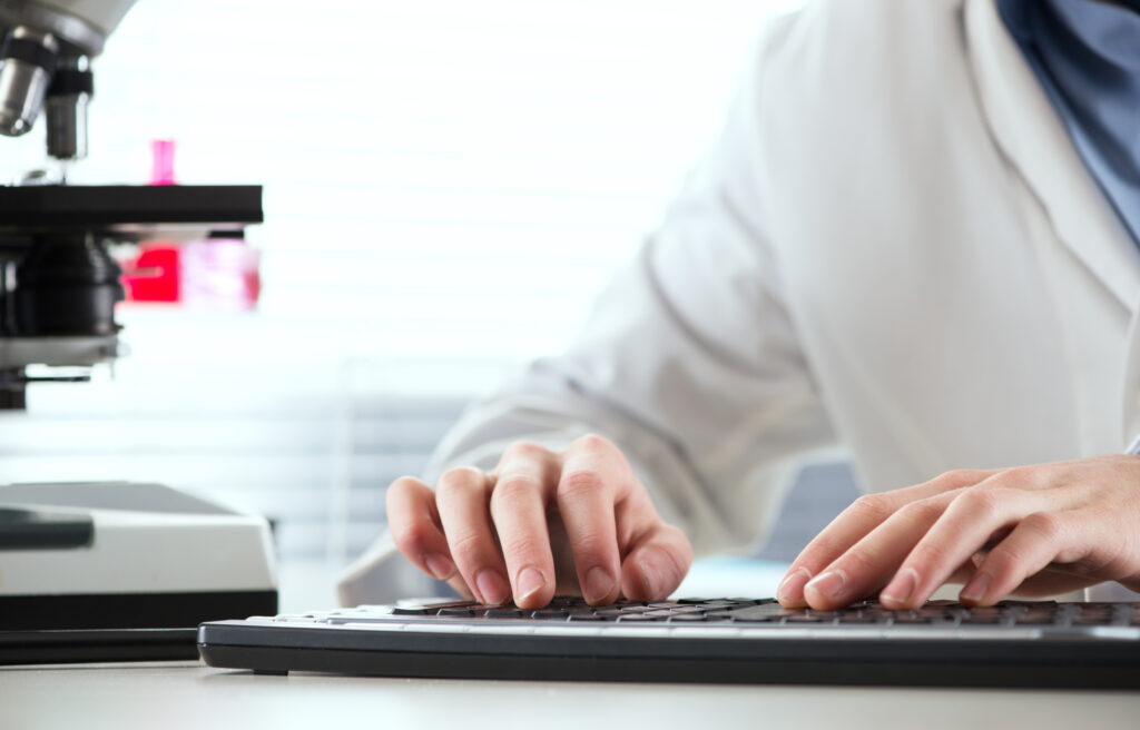 Doctor typing on a keyboard.